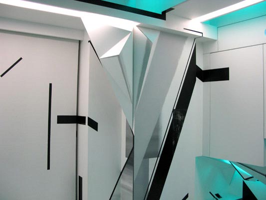 Futuristic interior wall with sharp origami-like folds, black line accents, and cyan light